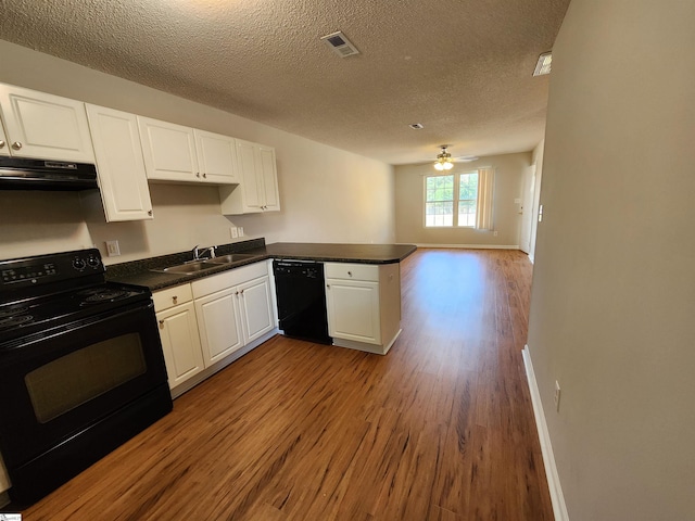 kitchen with black appliances, white cabinets, sink, a textured ceiling, and kitchen peninsula