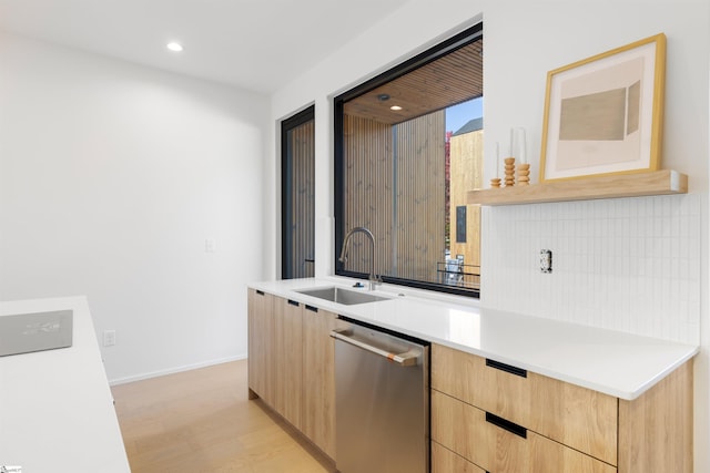 kitchen featuring backsplash, sink, light hardwood / wood-style flooring, stainless steel dishwasher, and light brown cabinetry