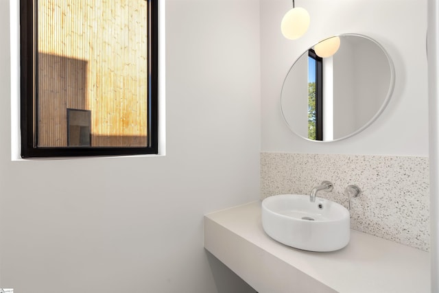 bathroom featuring sink and tasteful backsplash