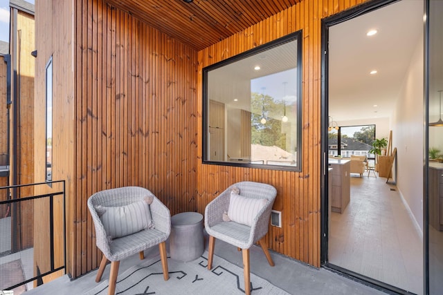 sitting room featuring wooden walls