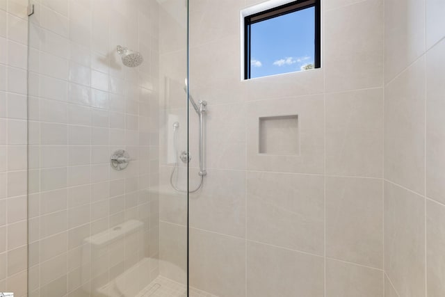 bathroom with a tile shower