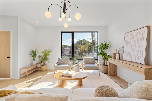 living room with light hardwood / wood-style flooring and a chandelier