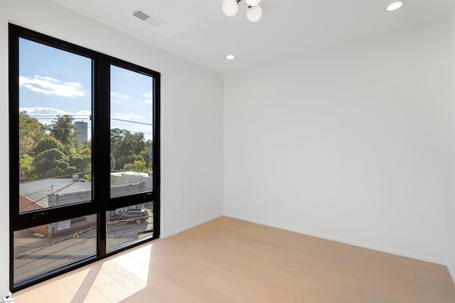 unfurnished room with light hardwood / wood-style flooring