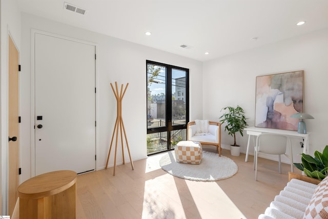 sitting room featuring light hardwood / wood-style flooring