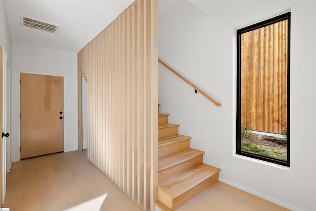 stairway with hardwood / wood-style flooring