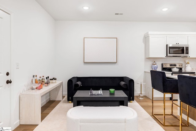 living room with light hardwood / wood-style flooring