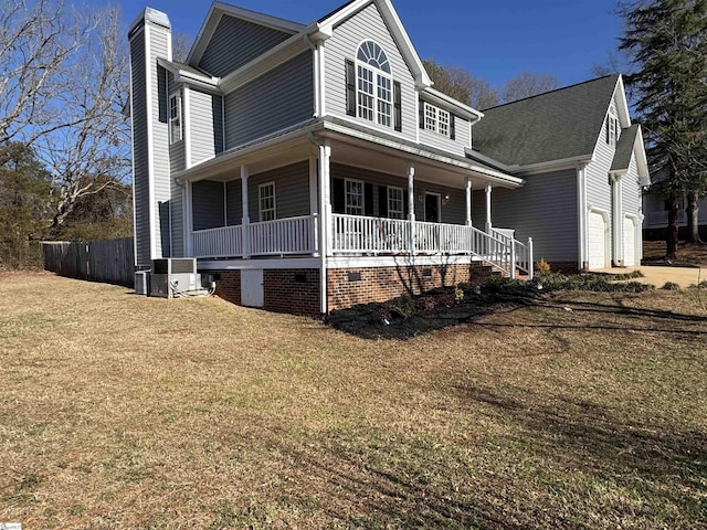 view of front facade featuring central air condition unit, a front lawn, covered porch, and a garage