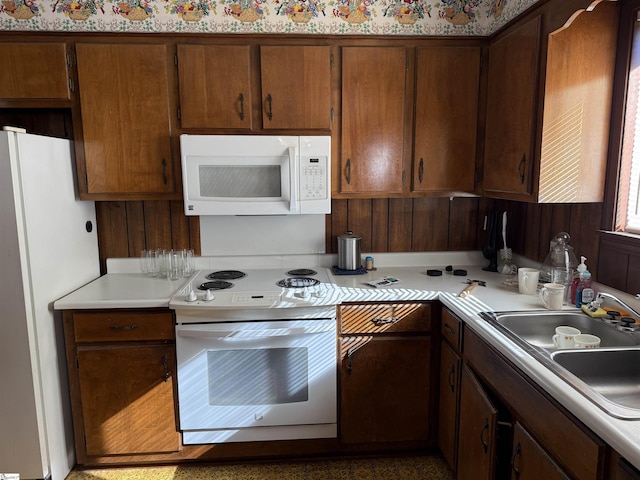 kitchen featuring white appliances and sink