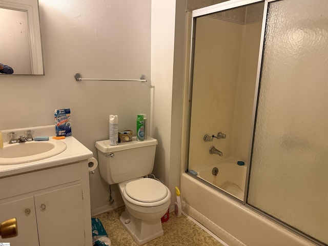 full bathroom featuring vanity, toilet, and bath / shower combo with glass door