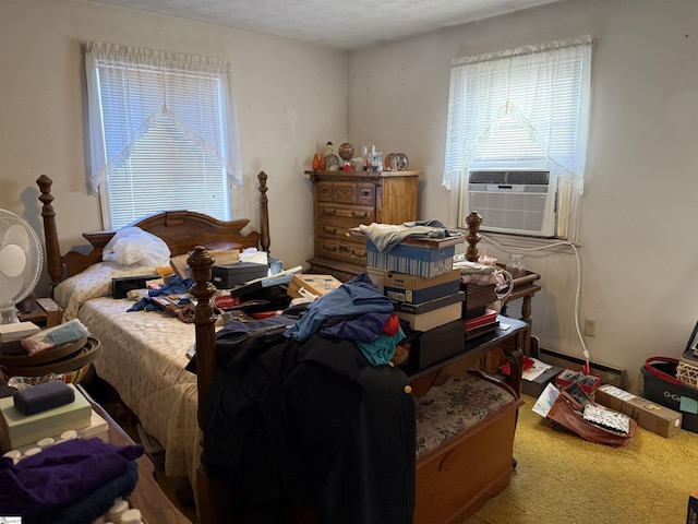 bedroom with carpet flooring, multiple windows, cooling unit, and a baseboard radiator