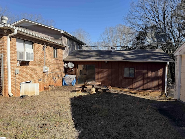 rear view of property with cooling unit