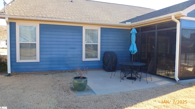 rear view of house with a patio area and a sunroom