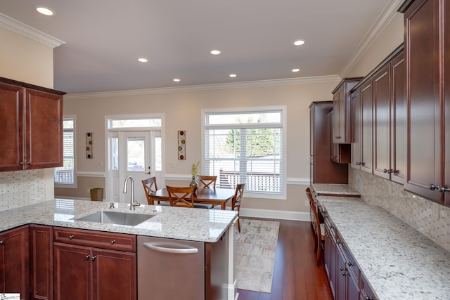 kitchen featuring light stone counters, ornamental molding, sink, and tasteful backsplash