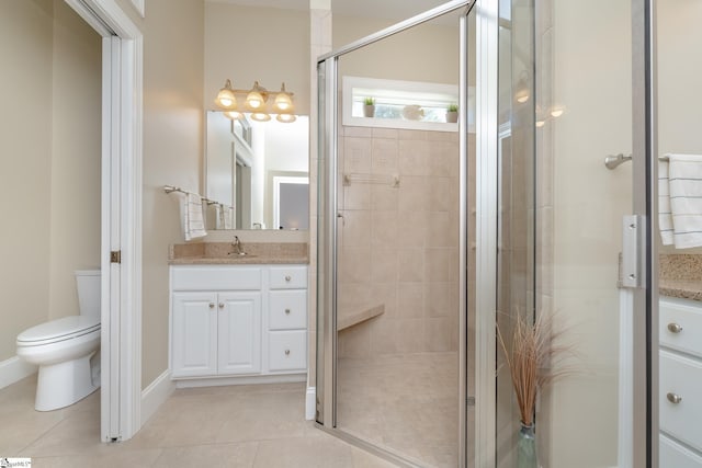 bathroom with tile patterned floors, vanity, toilet, and a shower with shower door