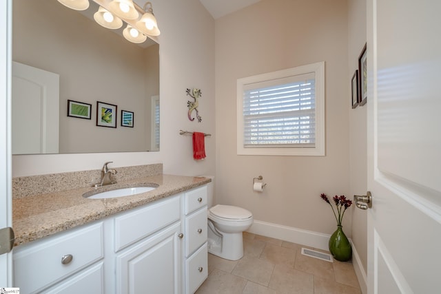 bathroom with tile patterned floors, vanity, and toilet