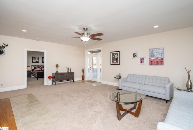 carpeted living room with ceiling fan and french doors