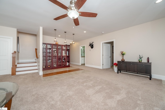 carpeted living room with ceiling fan