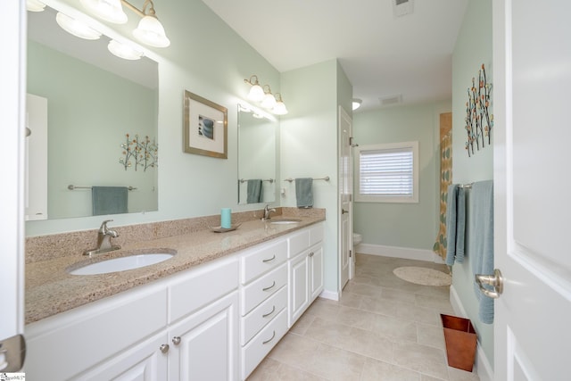 bathroom with tile patterned floors, vanity, and toilet