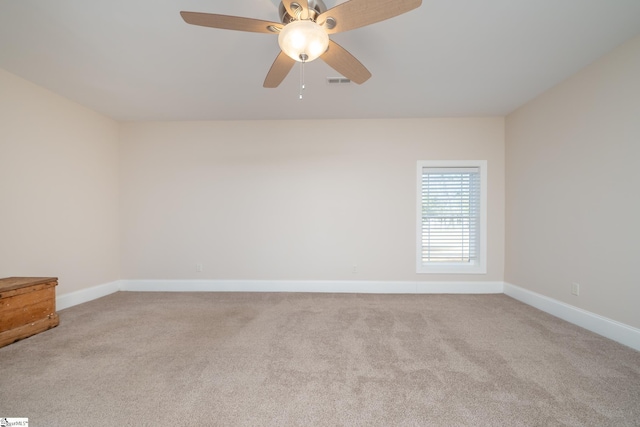 carpeted spare room with ceiling fan