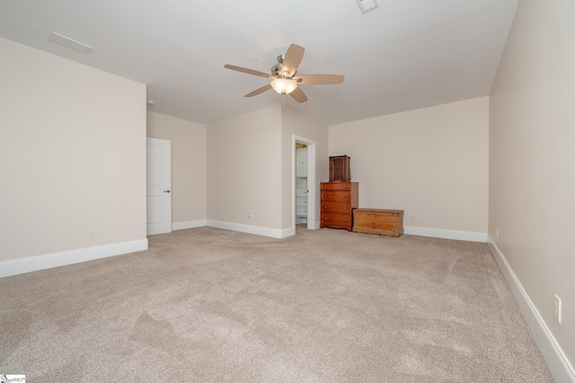 empty room featuring ceiling fan and light carpet