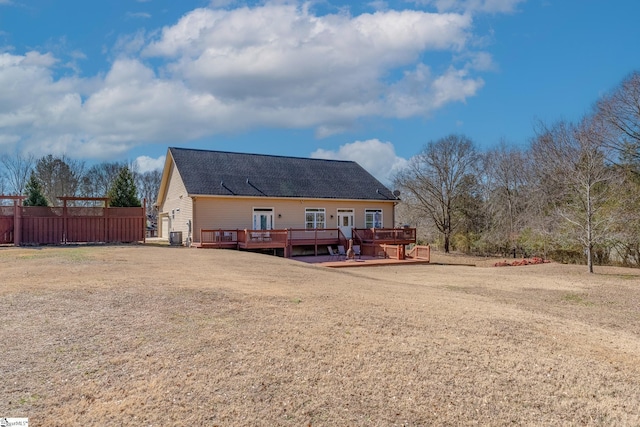 rear view of property featuring a wooden deck