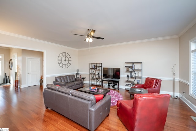 living room featuring ceiling fan, wood-type flooring, and ornamental molding