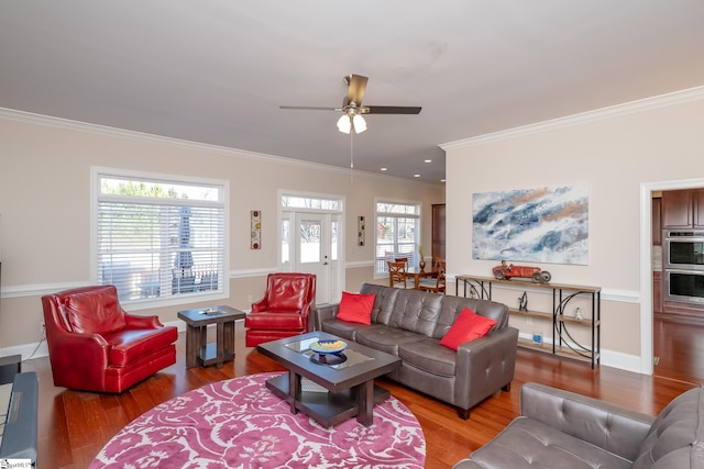 living room with hardwood / wood-style floors, ceiling fan, and crown molding