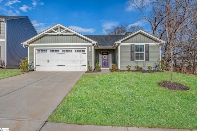 view of front of home featuring a front yard and a garage