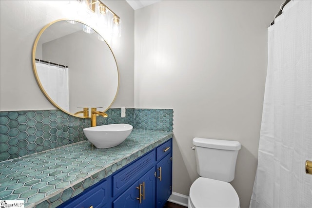 bathroom featuring decorative backsplash, toilet, and vanity