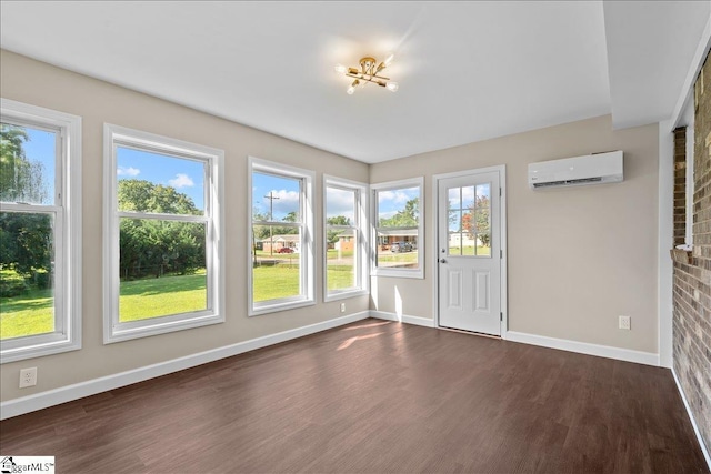 unfurnished sunroom featuring a wall unit AC