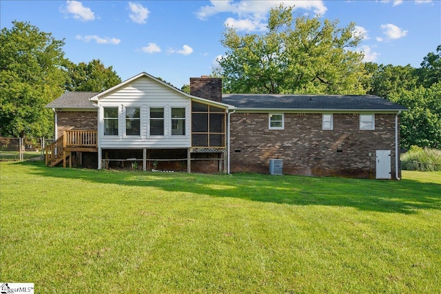 back of house with a lawn, a wooden deck, a sunroom, and central AC unit