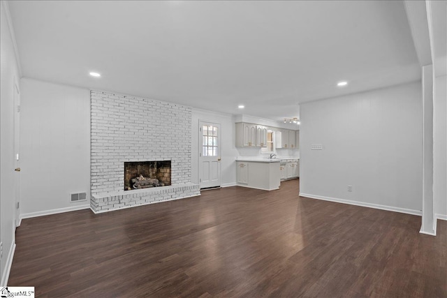 unfurnished living room with a fireplace and dark hardwood / wood-style floors