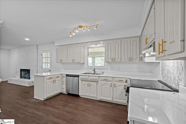 kitchen with dishwasher, white cabinets, a brick fireplace, and sink