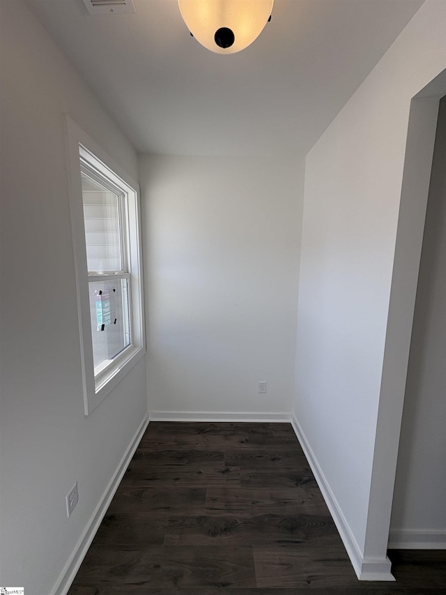 empty room featuring dark wood-type flooring