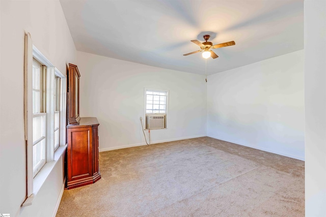 empty room featuring ceiling fan, cooling unit, and light carpet