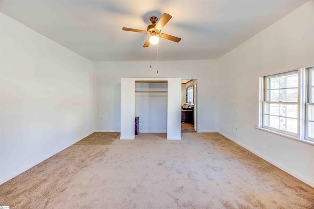 unfurnished bedroom with ceiling fan and light carpet