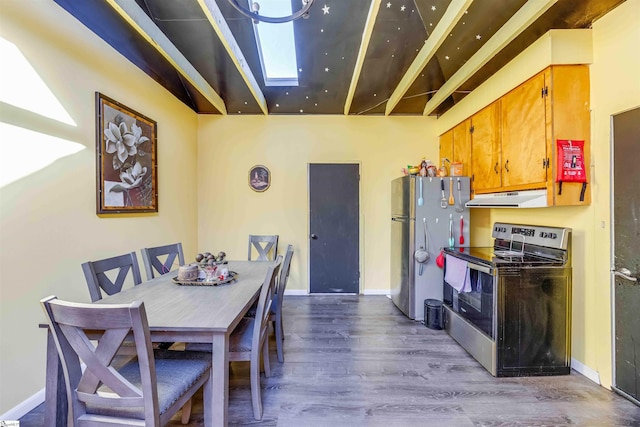 kitchen featuring stainless steel appliances, a skylight, and dark hardwood / wood-style floors