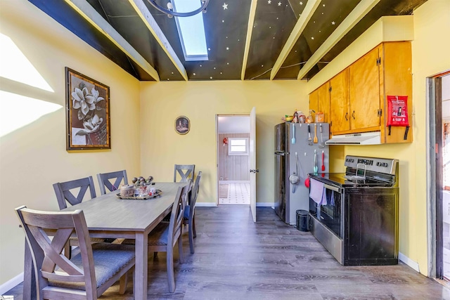 dining room with dark hardwood / wood-style flooring and a skylight