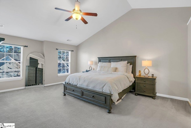 carpeted bedroom with ceiling fan, lofted ceiling, and multiple windows