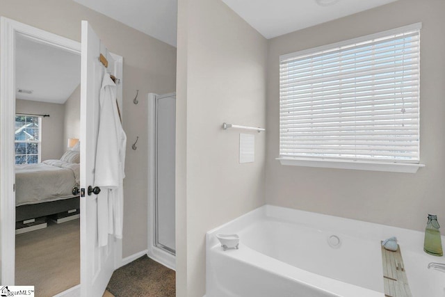 bathroom with separate shower and tub and lofted ceiling