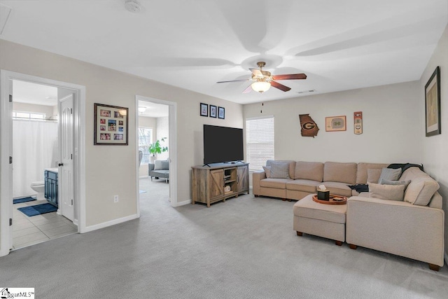 carpeted living room featuring ceiling fan