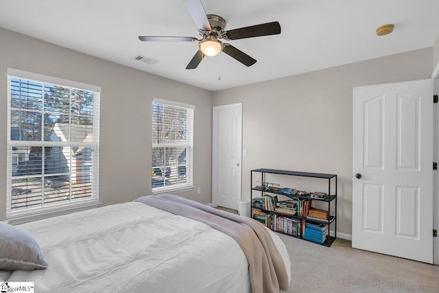 bedroom with light carpet and ceiling fan