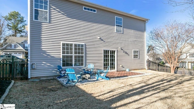 rear view of house featuring a lawn and a patio