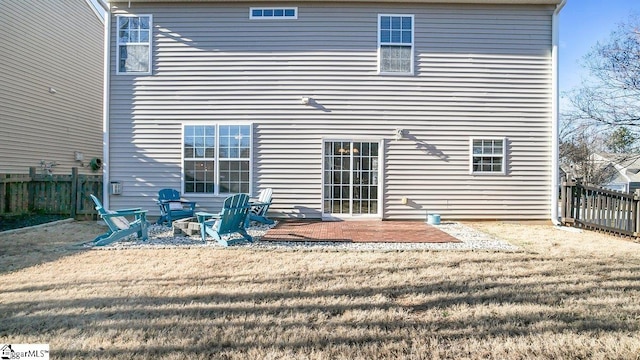 rear view of house featuring a lawn and a patio area