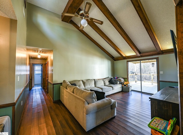 living room featuring beam ceiling, ceiling fan, and dark hardwood / wood-style floors