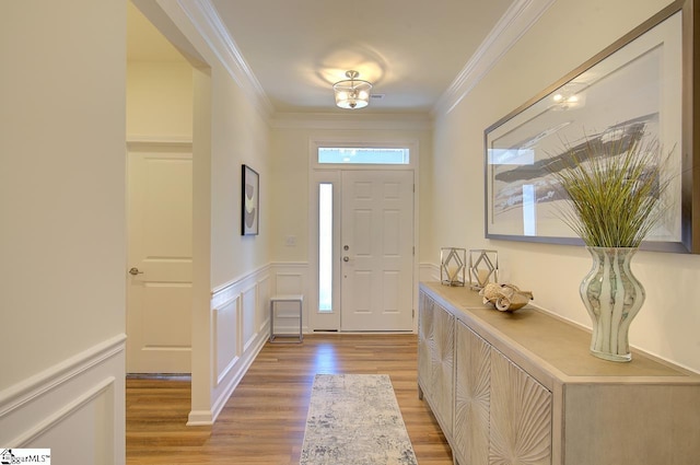 foyer featuring light hardwood / wood-style floors and ornamental molding