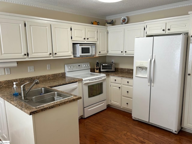 kitchen with sink, dark wood-type flooring, kitchen peninsula, white appliances, and white cabinets