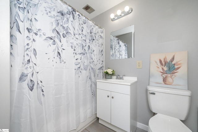 bathroom featuring vanity, a shower with shower curtain, and toilet