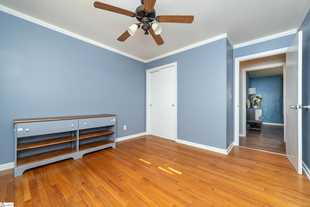 unfurnished bedroom with hardwood / wood-style floors, ceiling fan, and ornamental molding