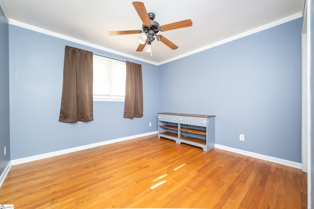 spare room with ceiling fan, crown molding, and light hardwood / wood-style flooring